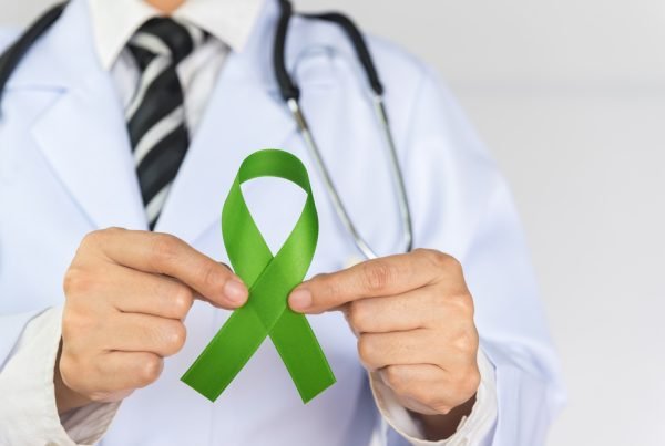 DLBCL Diagnosis and First Line Treatment: Doctor Haematologist holding a ribbon for lymphoma